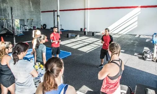 Coaches with members at Redline Conditioning