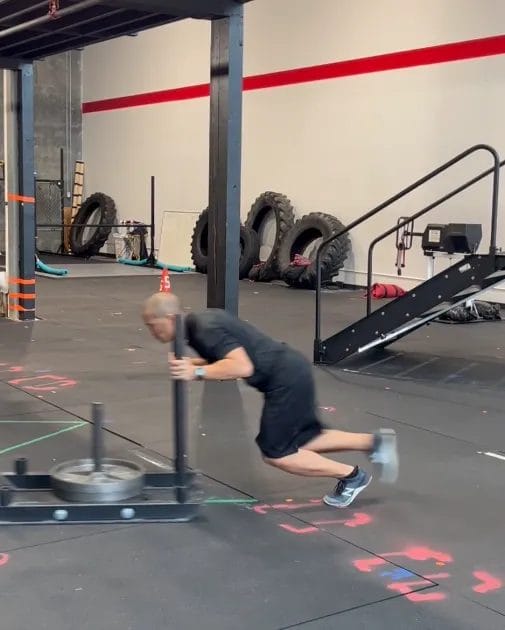 Man pushing sled at Redline Conditioning